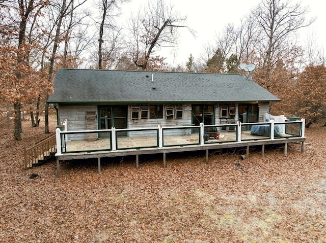 rear view of house featuring a wooden deck