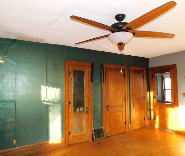 unfurnished room with hardwood / wood-style floors and ceiling fan