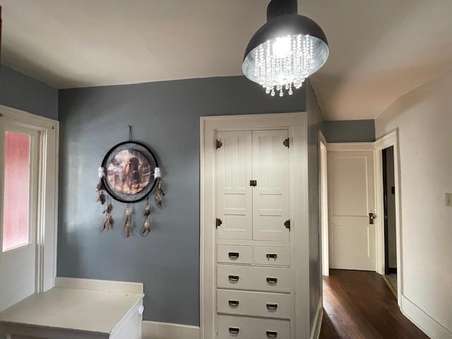 interior space featuring dark hardwood / wood-style floors and a chandelier