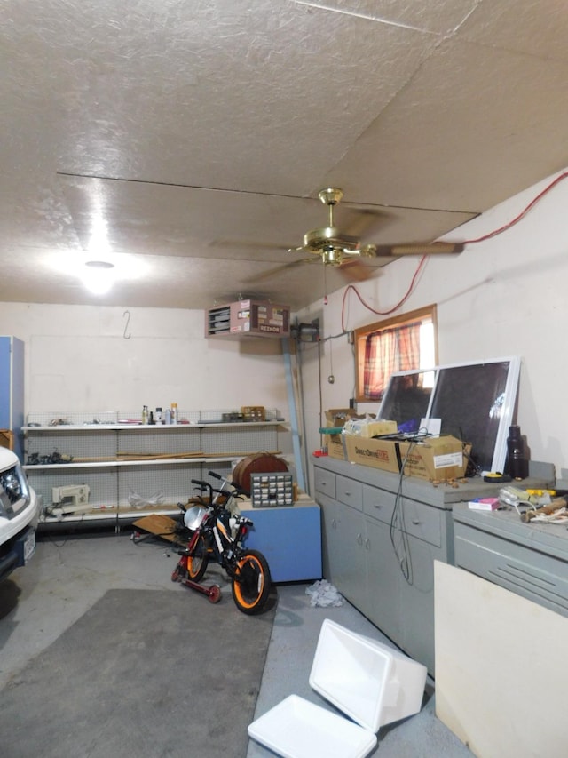 basement featuring a workshop area and a textured ceiling