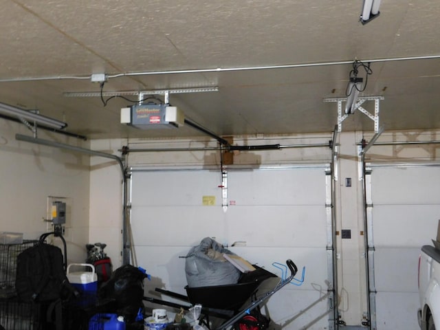 garage featuring a garage door opener and washer / clothes dryer