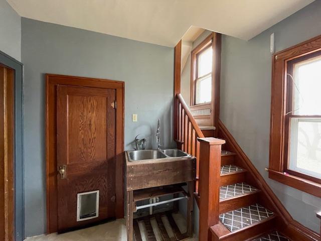 stairs featuring sink and a wealth of natural light