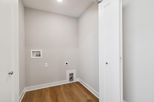 washroom featuring hookup for an electric dryer, wood-type flooring, a textured ceiling, and washer hookup