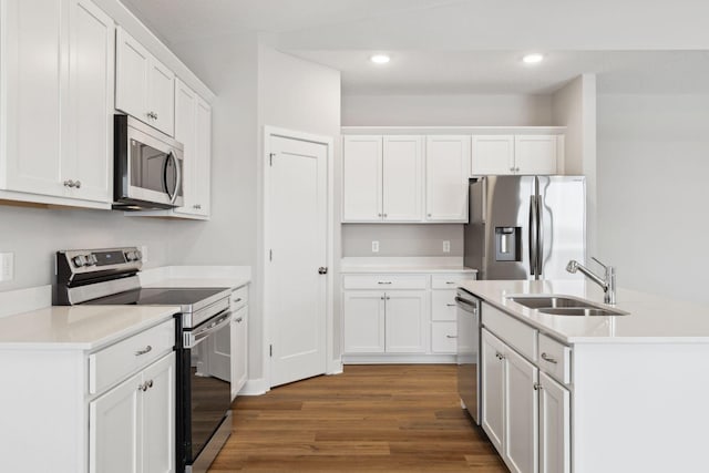 kitchen featuring stainless steel appliances, white cabinetry, dark hardwood / wood-style floors, and sink