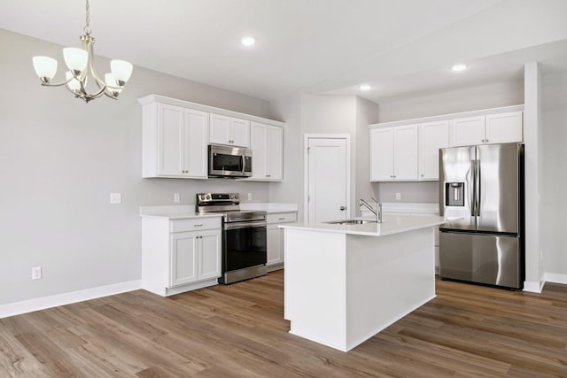 kitchen featuring hardwood / wood-style floors, white cabinets, and appliances with stainless steel finishes