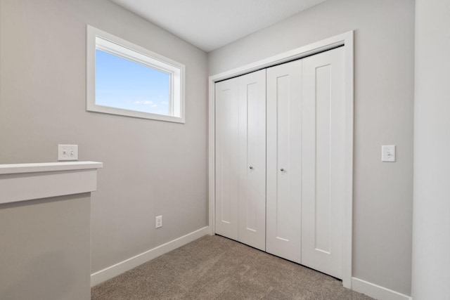 unfurnished bedroom with light carpet and a closet