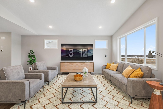 living room featuring light hardwood / wood-style flooring and lofted ceiling