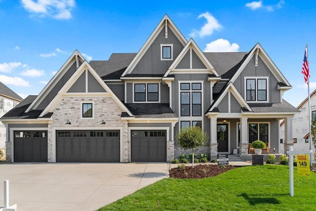 craftsman house featuring a front yard and a garage