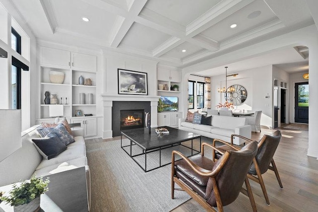 living room with beam ceiling, a wealth of natural light, light hardwood / wood-style floors, and coffered ceiling