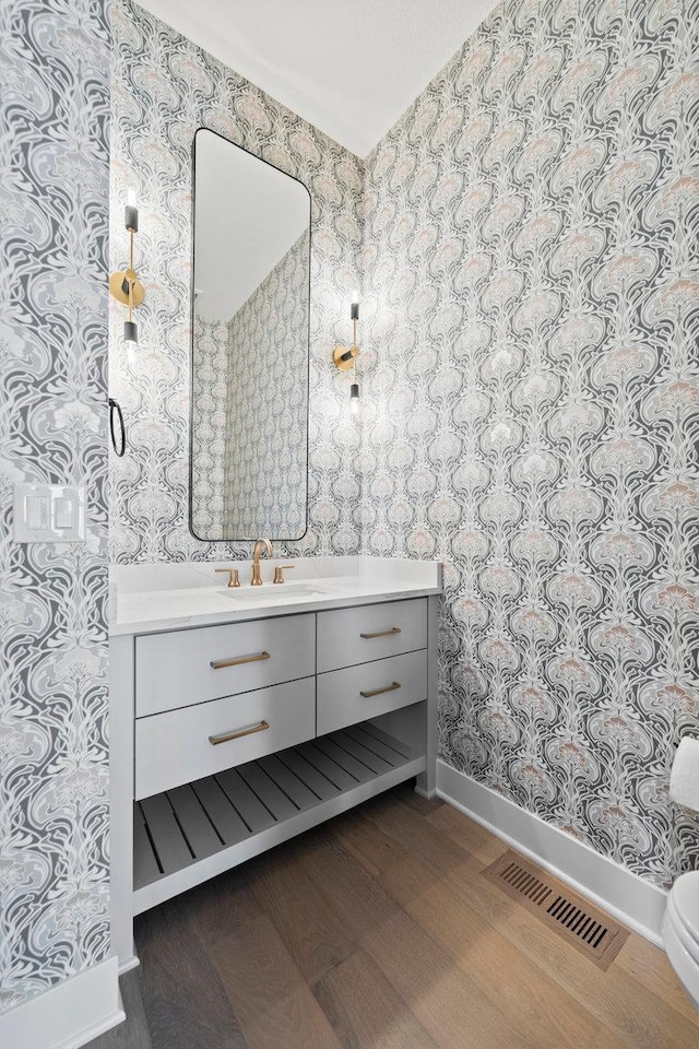 bathroom with vanity and hardwood / wood-style flooring