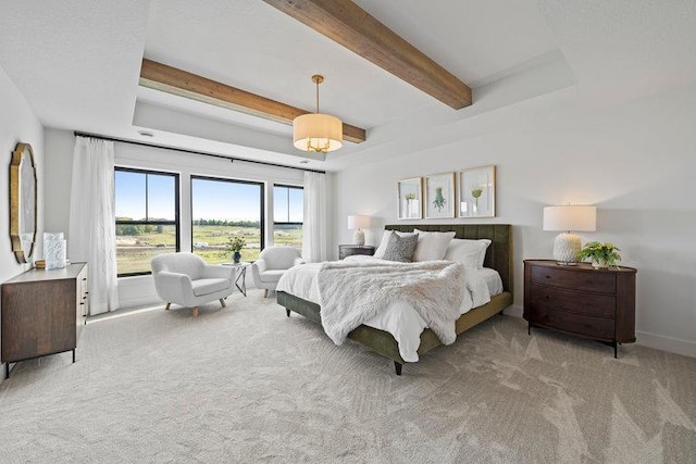 bedroom with beam ceiling and light colored carpet