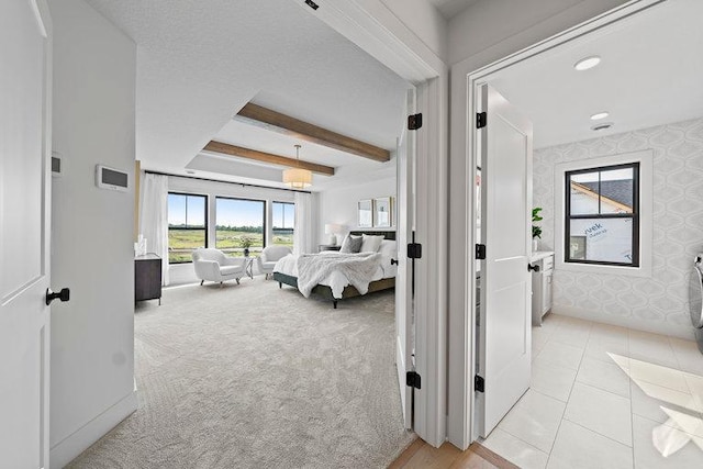 bedroom with light carpet and beam ceiling