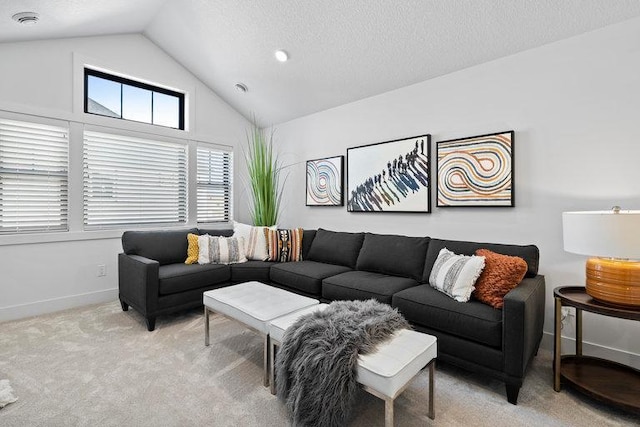 living room with light carpet, a textured ceiling, and vaulted ceiling