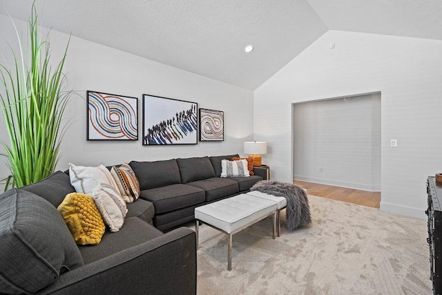 living room featuring light colored carpet and vaulted ceiling