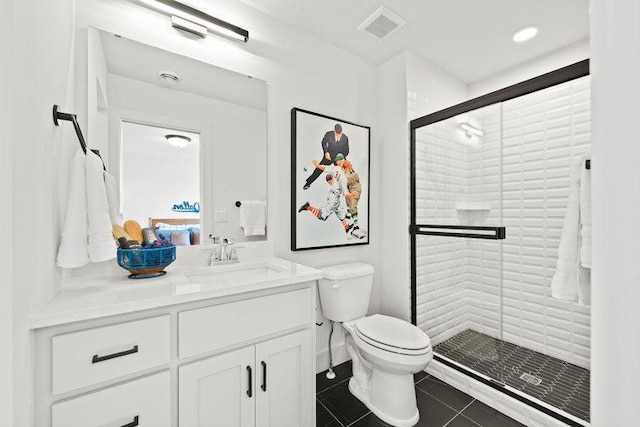 bathroom featuring tile patterned flooring, vanity, toilet, and a shower with shower door