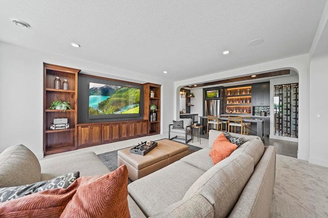 living room featuring bar and a textured ceiling