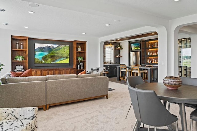 carpeted living room with indoor wet bar