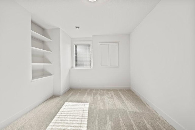 unfurnished room with light colored carpet