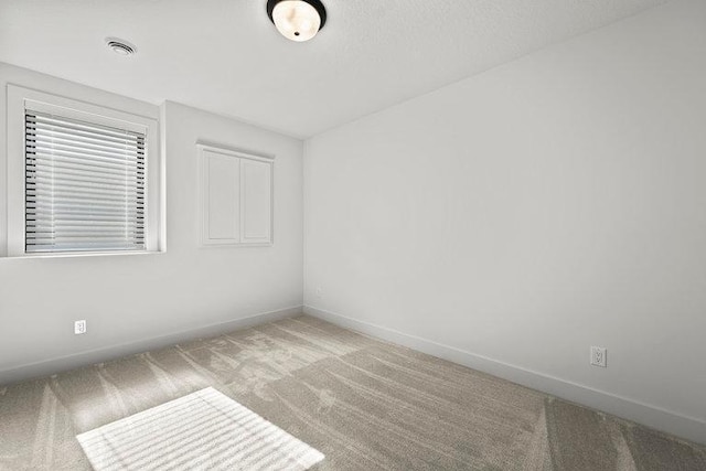 unfurnished room with light colored carpet