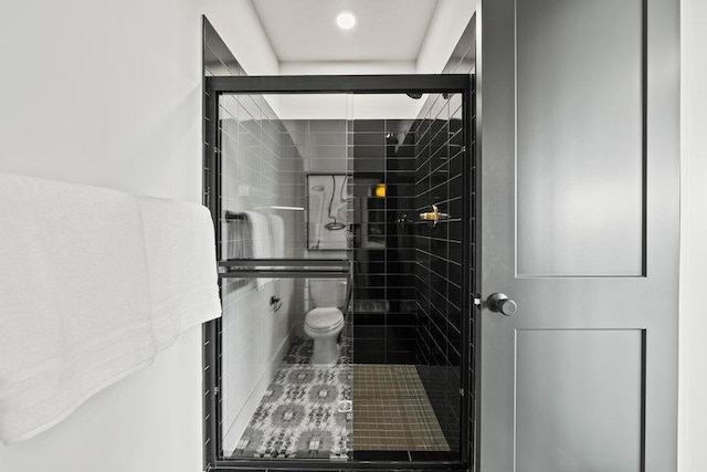 bathroom featuring a shower with shower door