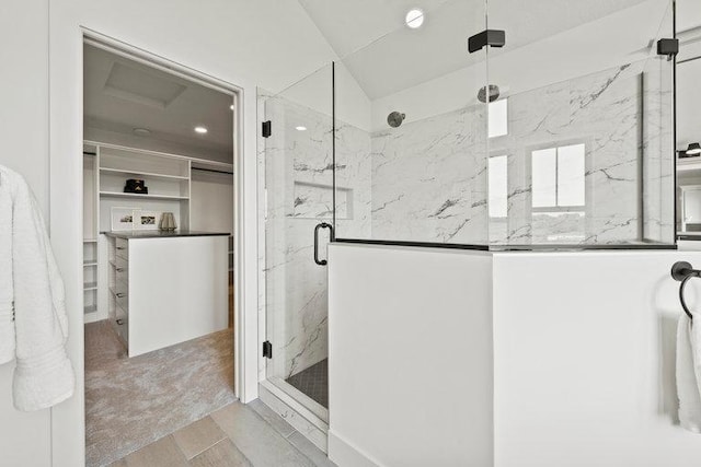 bathroom featuring a marble finish shower