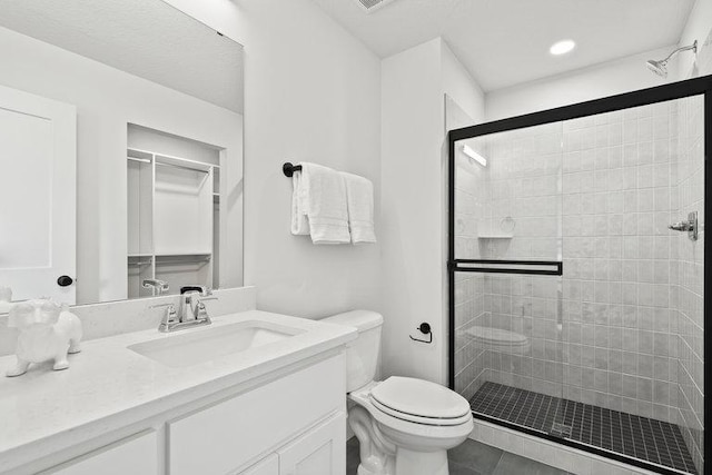 full bathroom with a shower stall, toilet, and vanity