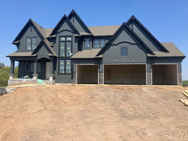 4732 Ogden Trl N, Stillwater, MN 55082 - craftsman-style home featuring dirt driveway, a garage, and roof with shingles