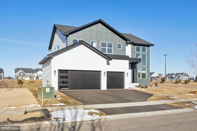 view of front of property featuring a garage and cooling unit