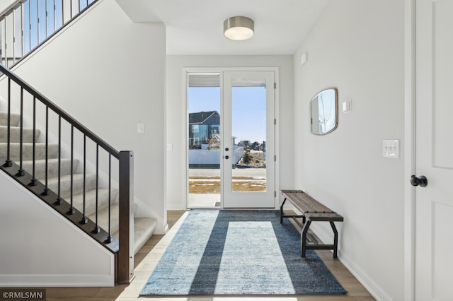 foyer featuring wood-type flooring and a healthy amount of sunlight