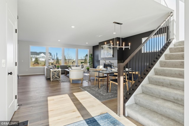 living room with hardwood / wood-style floors and an inviting chandelier