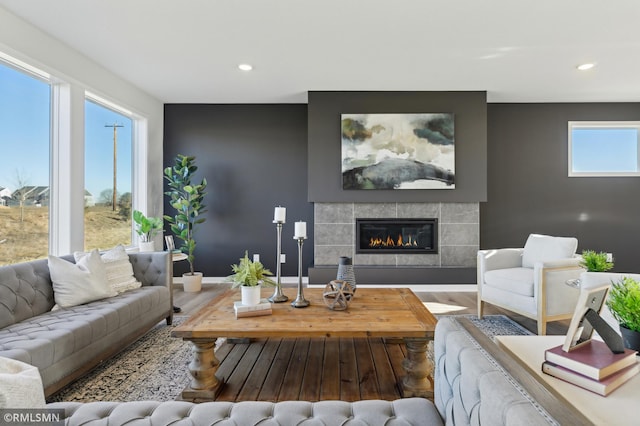 living room with hardwood / wood-style floors and a tile fireplace