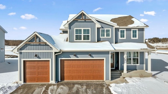 view of front of home with board and batten siding, covered porch, and a garage