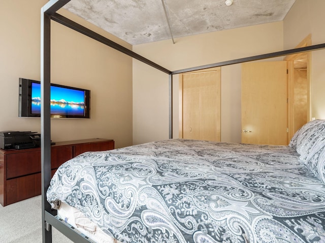 bedroom with carpet and a closet