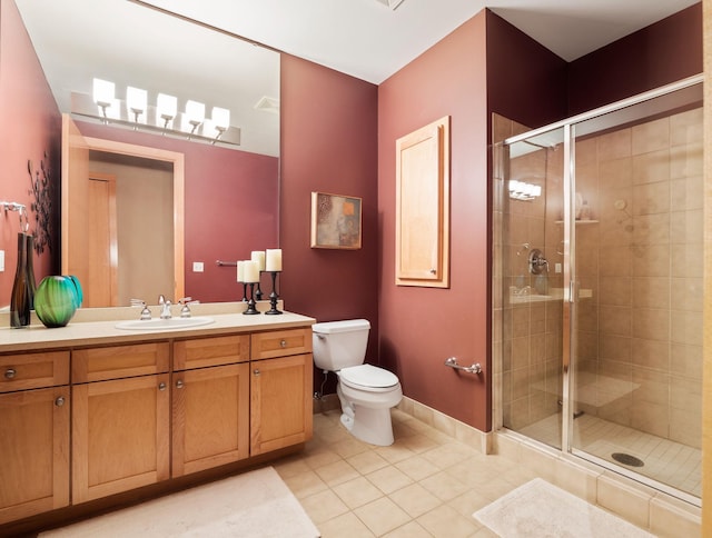 bathroom with tile patterned flooring, toilet, an enclosed shower, and vanity