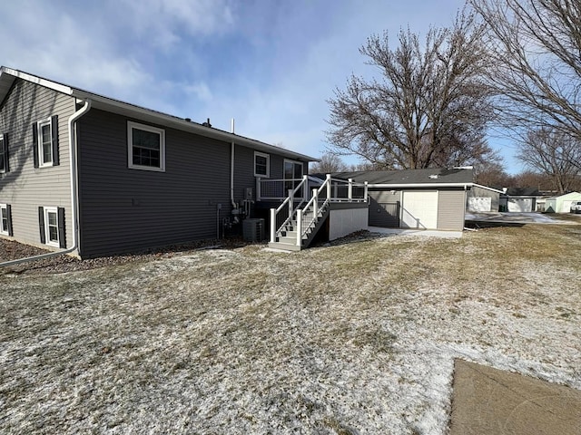 back of property with a wooden deck and central AC unit