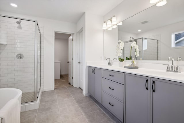 bathroom with vanity, tile patterned floors, and a shower with shower door