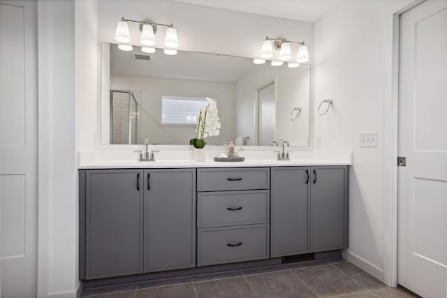 bathroom with tile patterned floors, vanity, and a shower with shower door