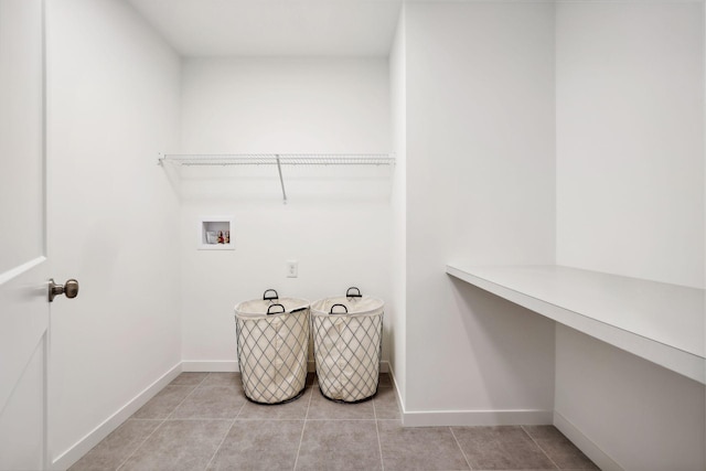 laundry room featuring light tile patterned flooring and washer hookup