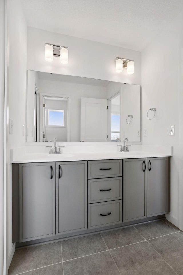 bathroom with tile patterned floors and vanity