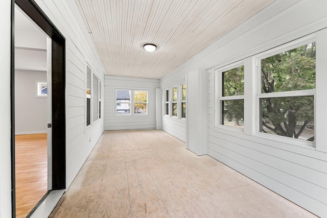 unfurnished sunroom with wood ceiling