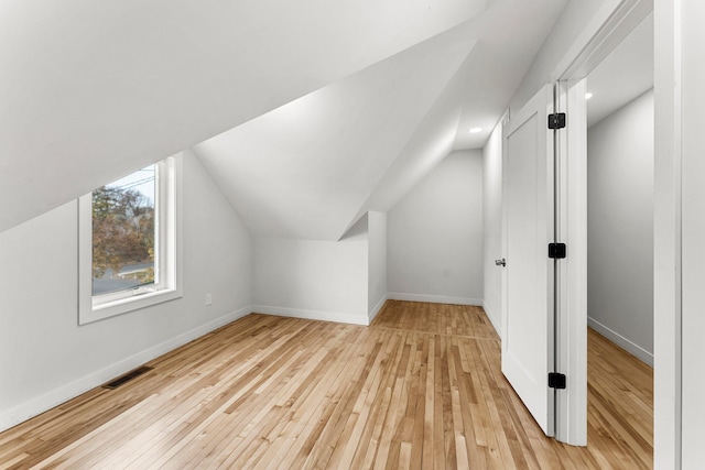 bonus room featuring light hardwood / wood-style floors and lofted ceiling