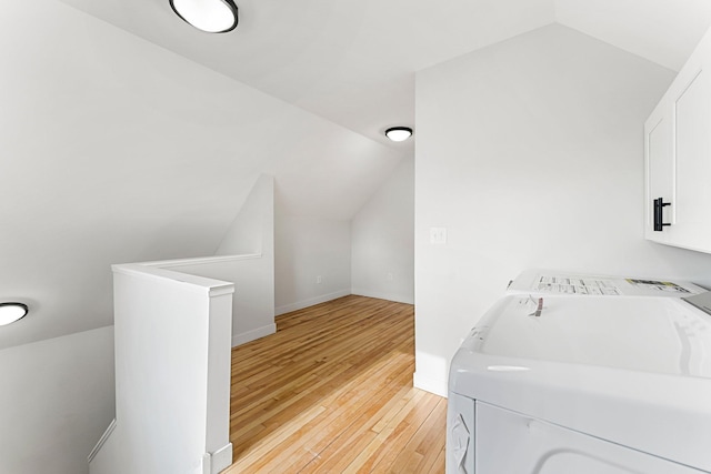 laundry area with washer / clothes dryer and light hardwood / wood-style floors