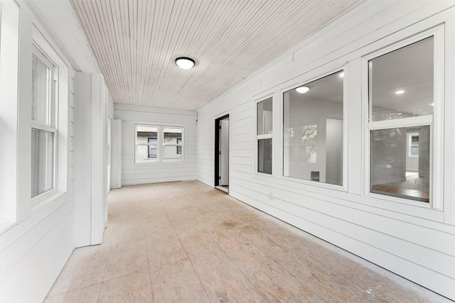 unfurnished sunroom featuring wood ceiling