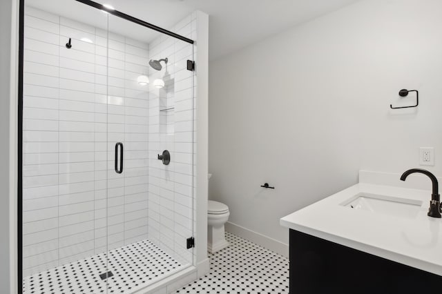 bathroom featuring vanity, toilet, and an enclosed shower