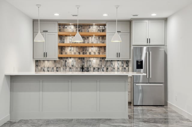 bar with pendant lighting, stainless steel fridge with ice dispenser, and tasteful backsplash