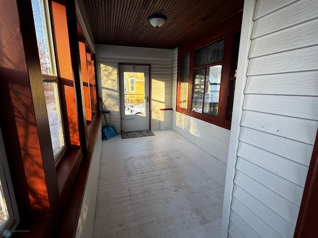 hallway featuring wood walls and wooden ceiling