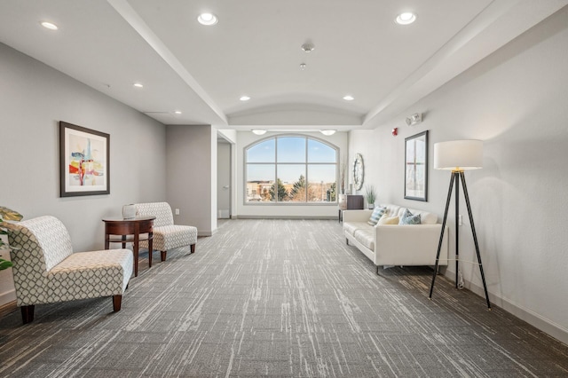 living area with carpet and vaulted ceiling