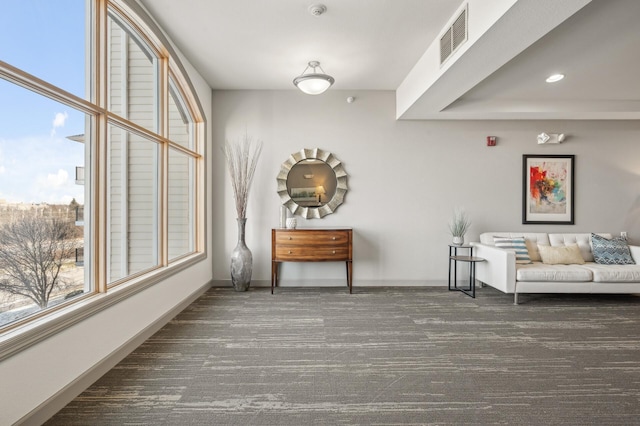 living area with dark carpet