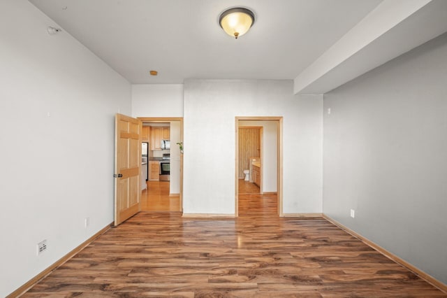 unfurnished room featuring dark wood-type flooring