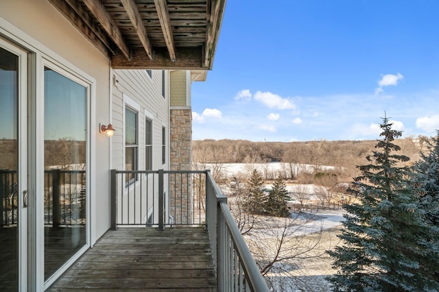 view of snow covered back of property